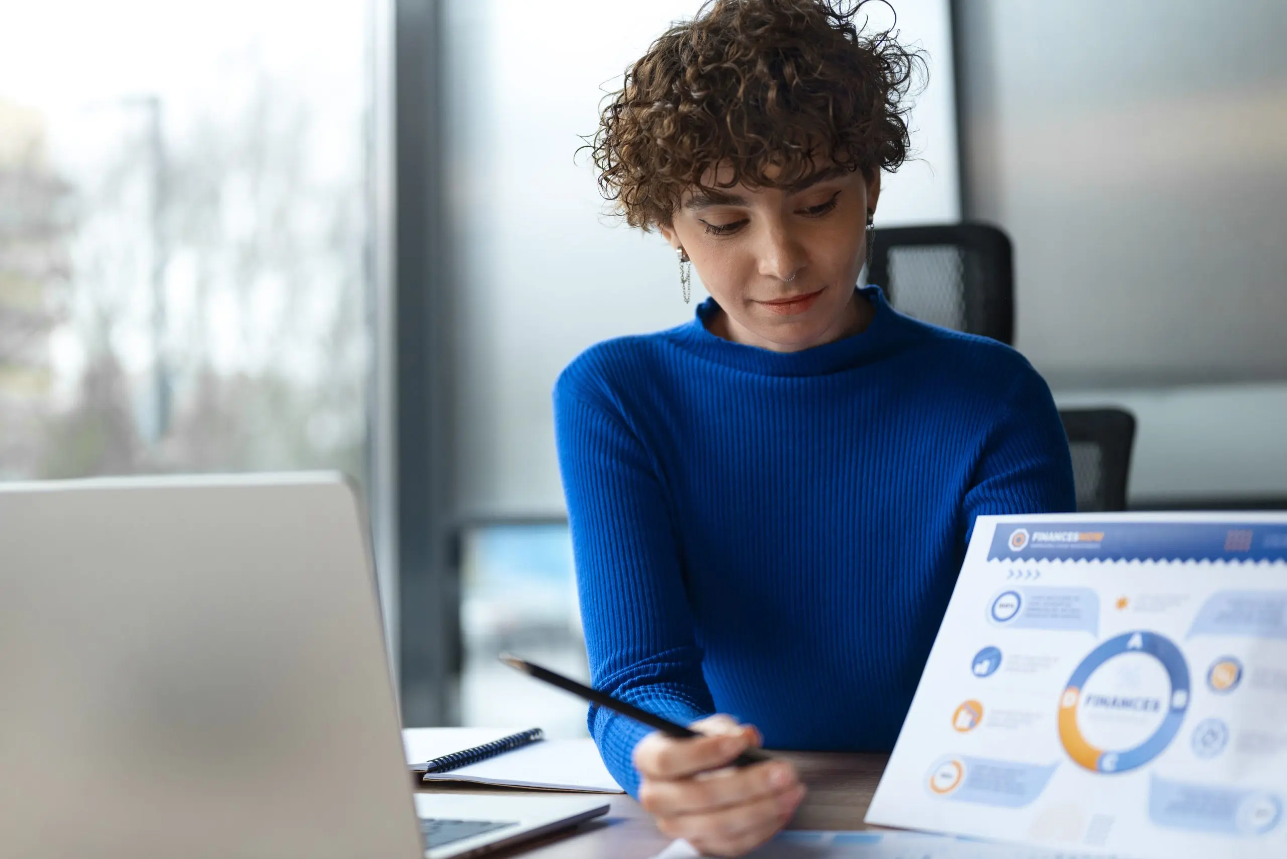 person office analyzing checking finance graphs